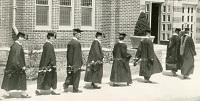 college graduates holding vines