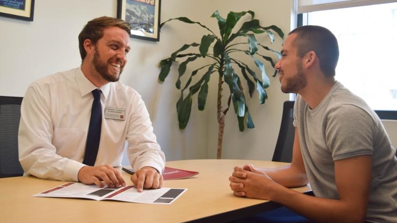 Admission counselor talking to a student