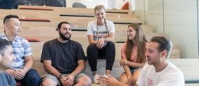 Students having a discussion while sitting on a staircase