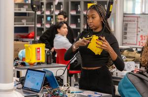 Students work in a lab, designing electronics.