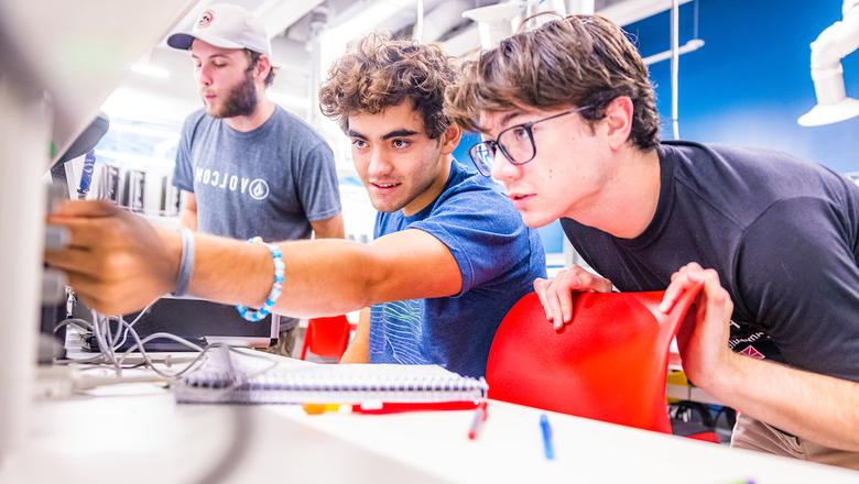 Students work on a project in a brightly lit lab.